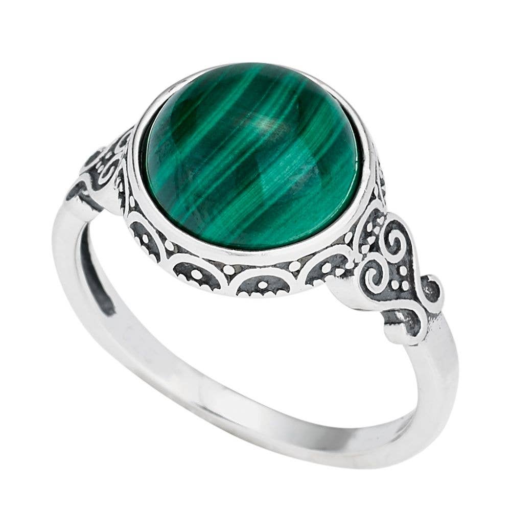 Silver ring with a green stone on a white background