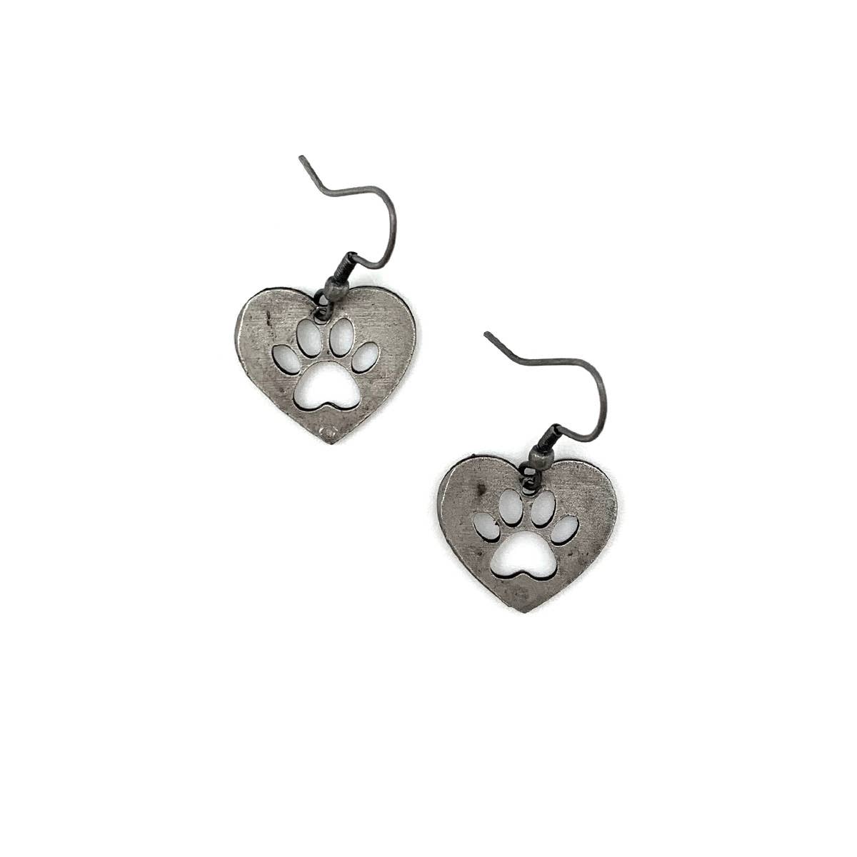 A pair of pewter earrings in the shape of hearts with paw prints cut outs.