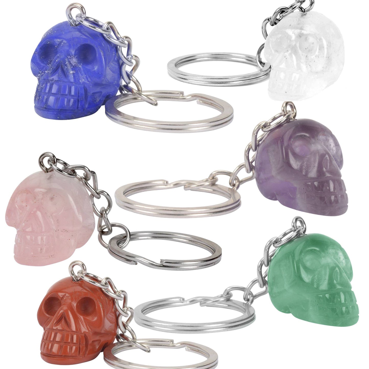 Set of colorful skull-shaped keychains on a white background