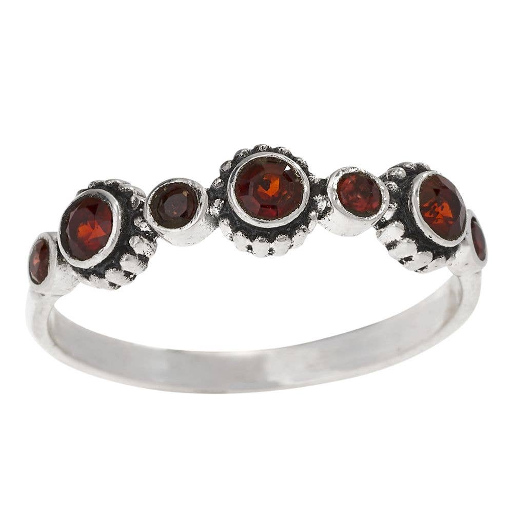 Silver ring with seven brown gemstones on a white background