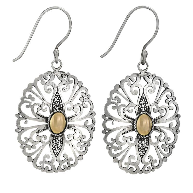 Silver filigree earrings with a central beige stone on a white background