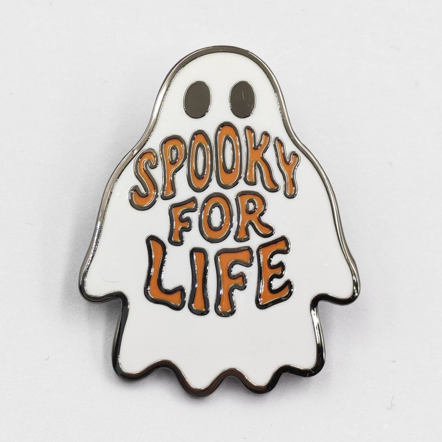 Ghost-shaped enamel pin with 'Spooky for Life' text on a white background