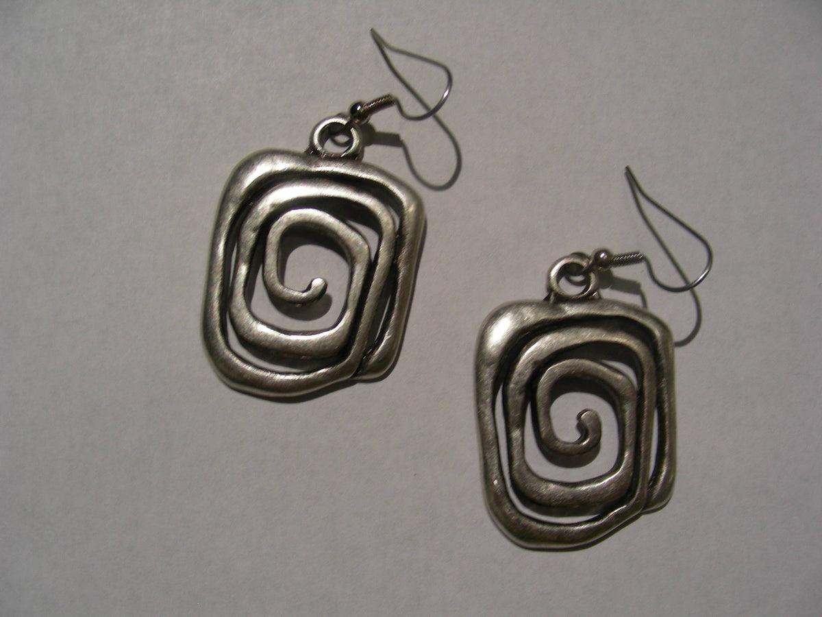 A pair of textured silver drop earrings with a spiral design, shown on a plain light gray background.