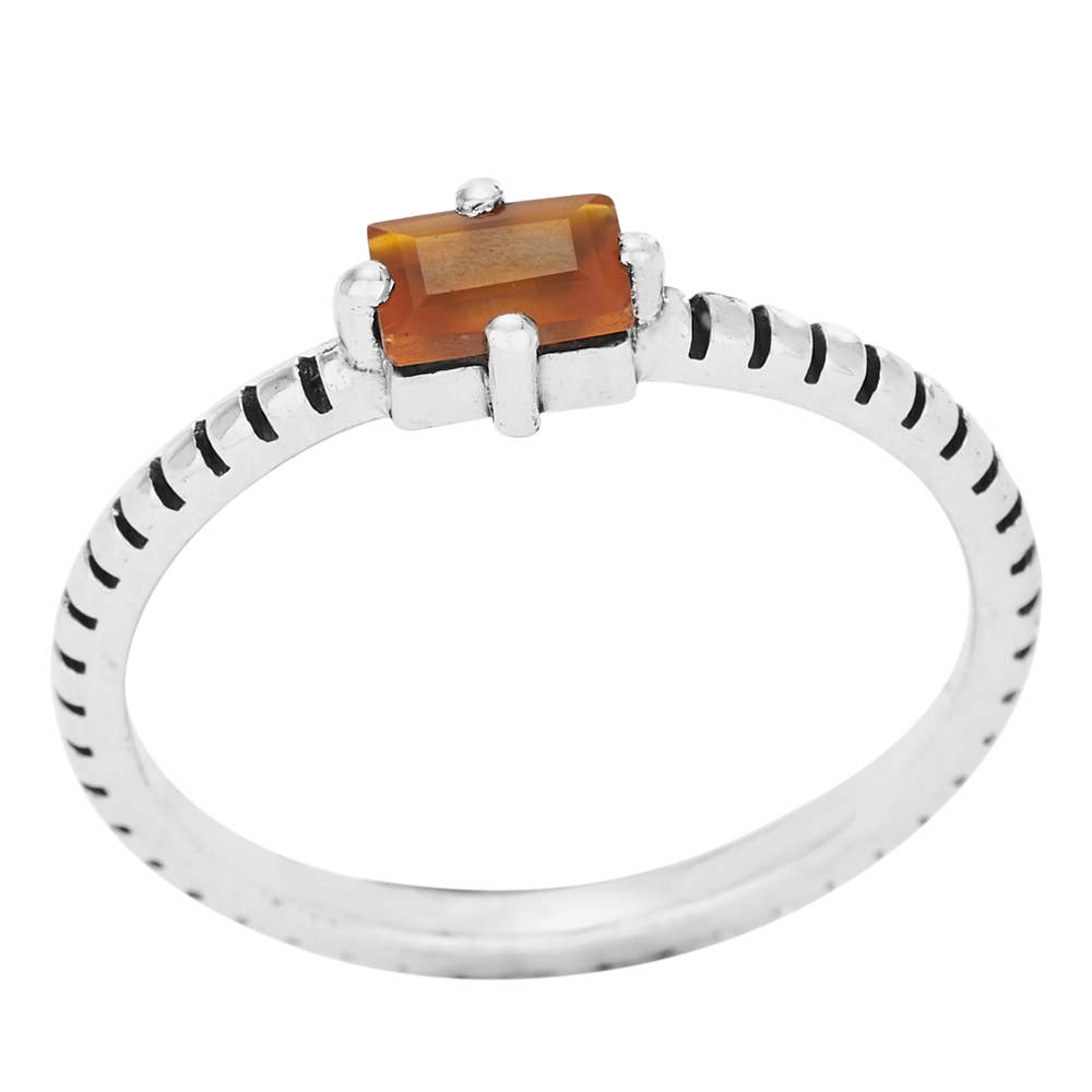 Ring with a rectangular brown gemstone on a white background