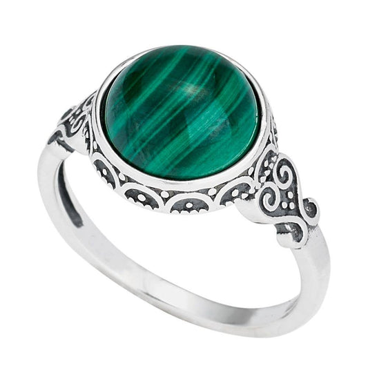 Silver ring with a green stone on a white background