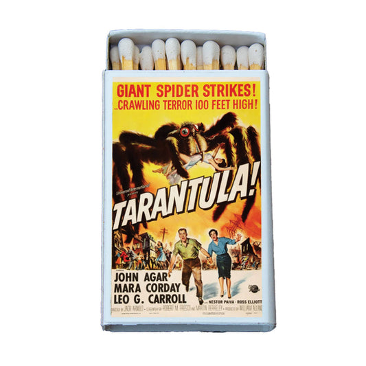 A novelty matchbox styled like a vintage movie poster for the film 'Tarantula!'. The matchbox is open, showing white match heads, and features a colorful poster design with a giant spider, bold title text, and actor names.
