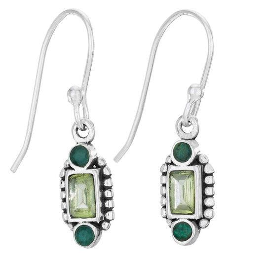 Silver earrings with green gemstones on a white background