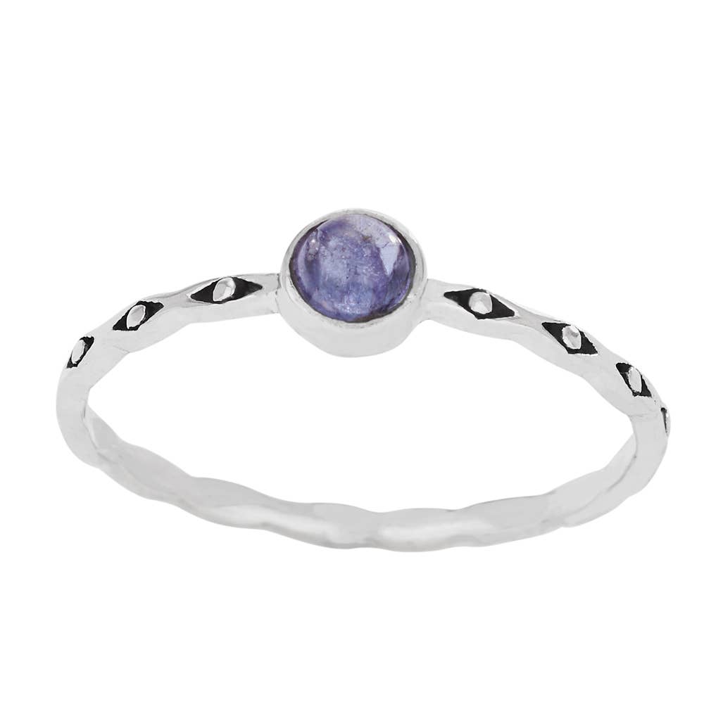 Silver ring with a purple gemstone on a white background