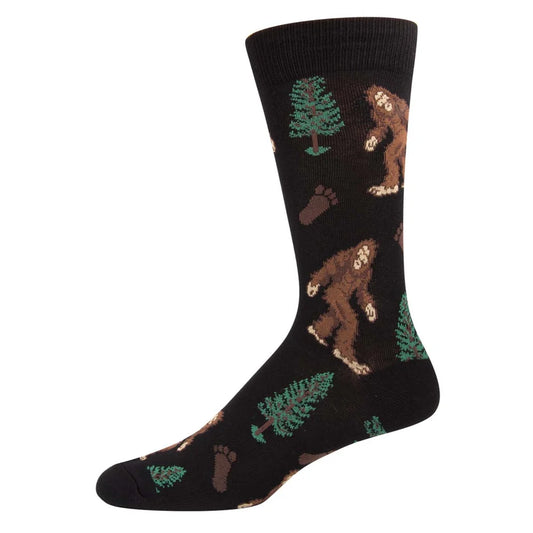 Black socks with Bigfoot, trees, and footprints on a black background.