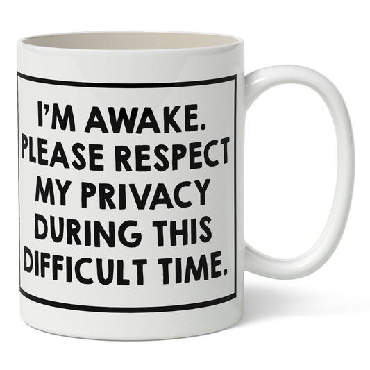 White mug with black "I'm awake" text on a white background