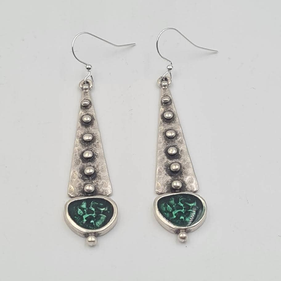 A pair of silver dangle earrings with textured triangular drops, small metallic beads, and oval green inlay details, shown on a plain light gray background.