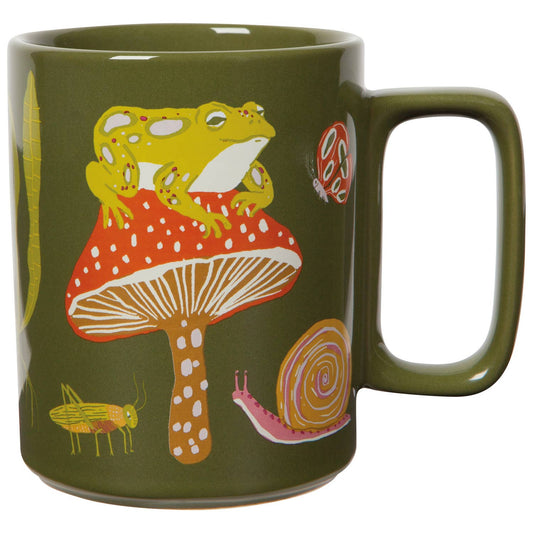 Green mug with a frog on a mushroom design on a white background