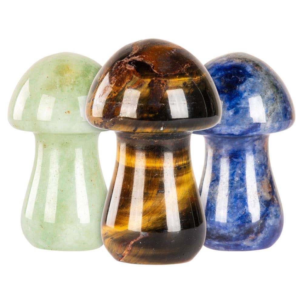 Three crystal mushrooms in green, brown, and blue on a white background