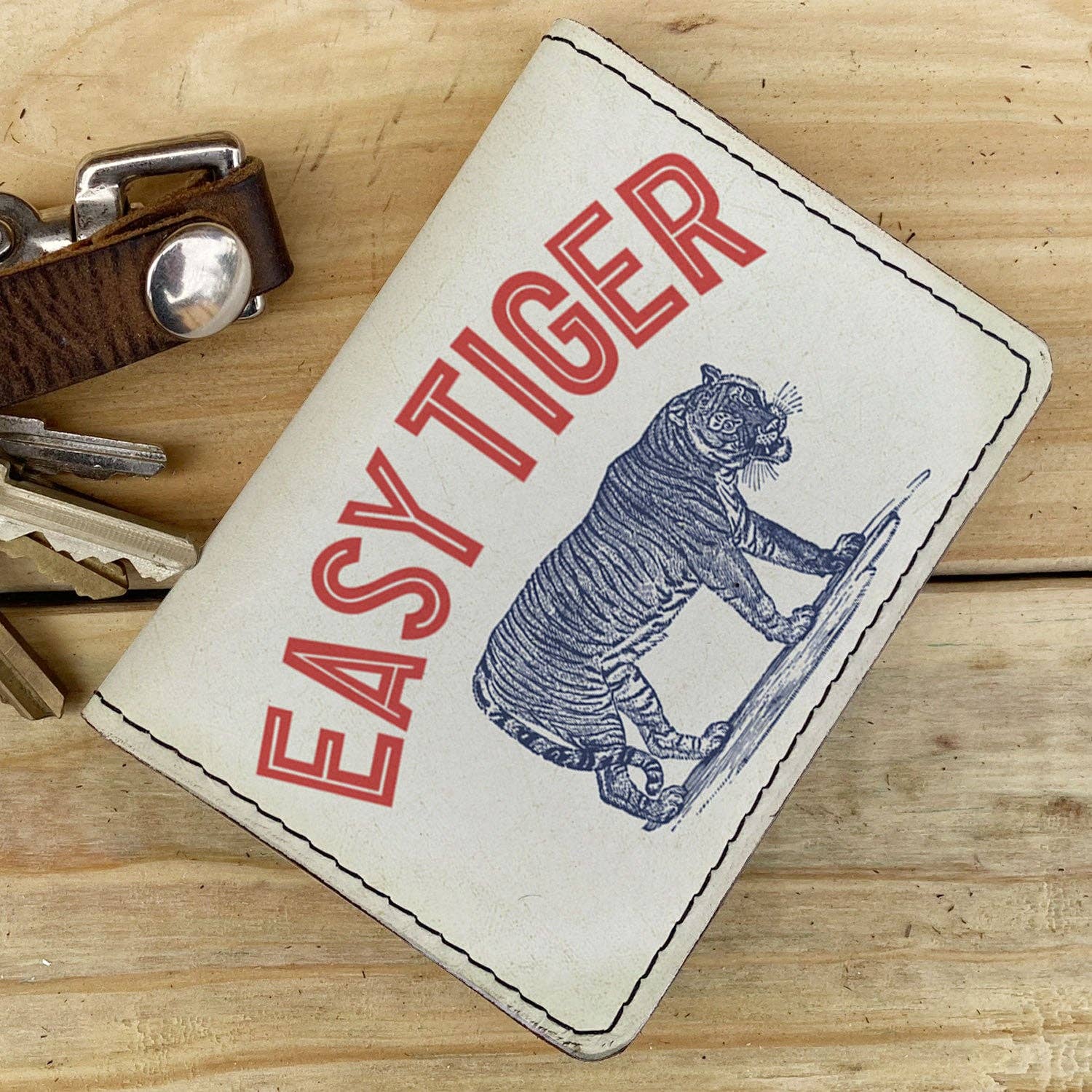 Wallet with 'Easy Tiger' and image of a Tiger design on a wooden surface