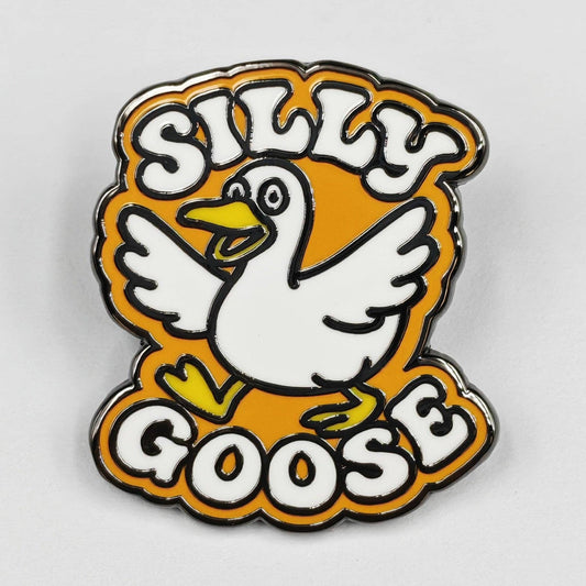 Enamel pin with a cartoon goose and 'Silly Goose' text on an orange background
