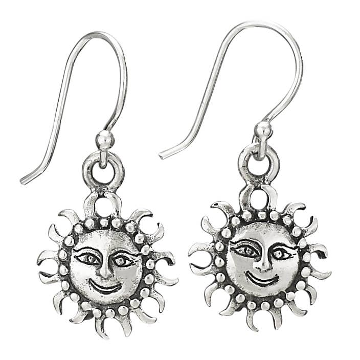 Silver sun-shaped earrings with face designs on a white background