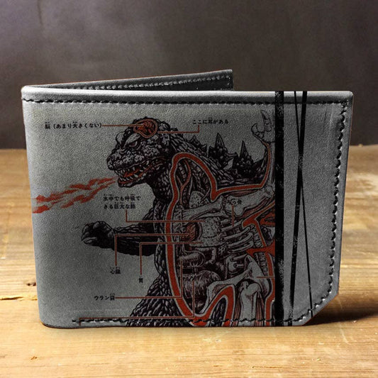 Gray wallet with Godzilla design on a wooden surface