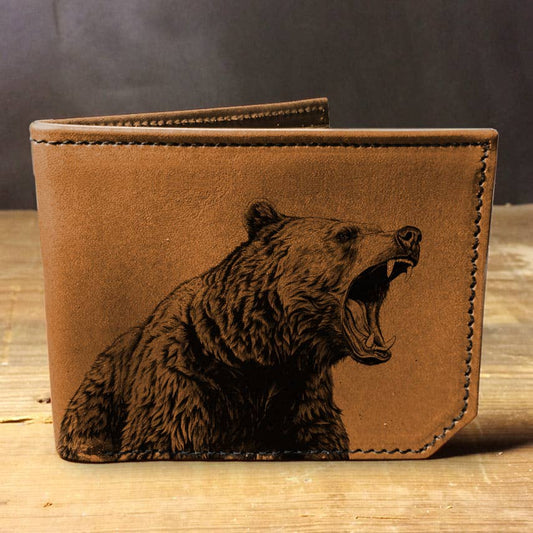 Brown leather wallet with Grizzly bear image on a wooden surface