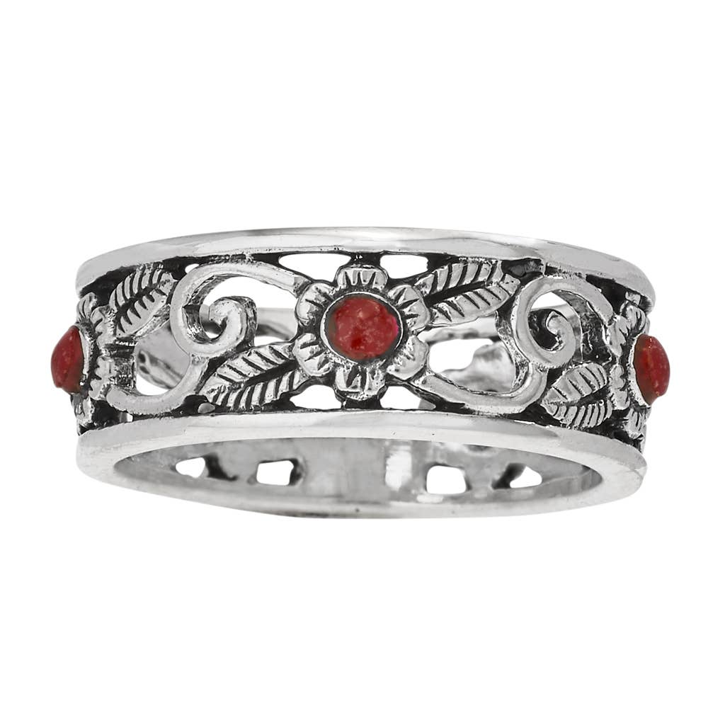 Silver ring with red stones on a white background