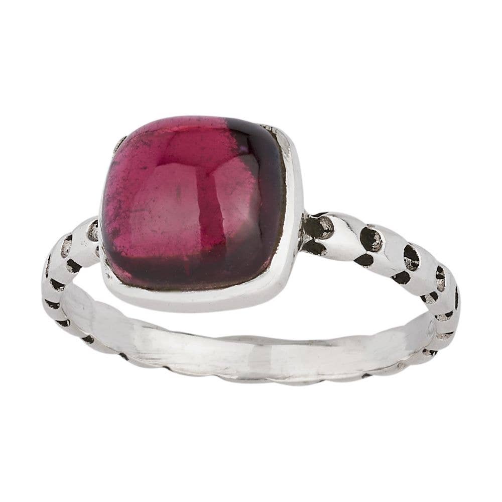 Silver ring with a pink gemstone on a white background