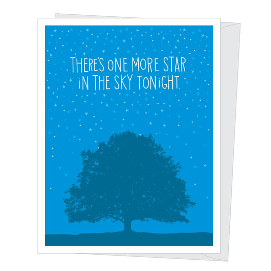 Greeting card with tree silhouette and starry sky, text 'There's one more star in the sky tonight' on blue background