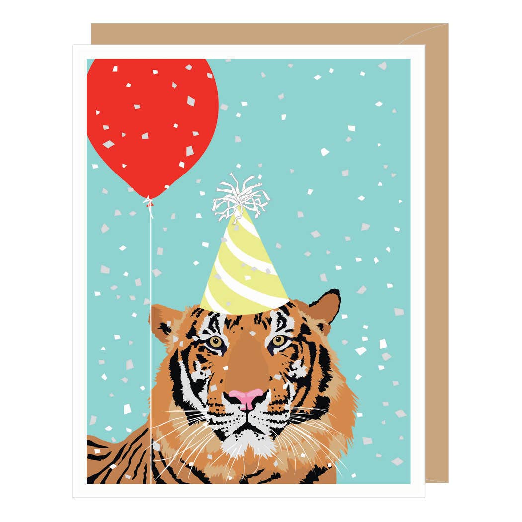 A birthday card featuring an illustrated tiger wearing a yellow party hat with white confetti on a light aqua background, with a red balloon and a tan envelope behind it.
