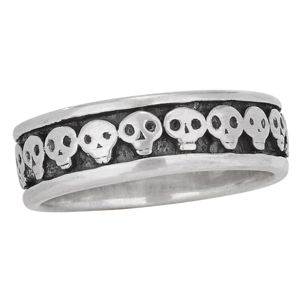 A sterling silver band ring featuring a row of raised skull motifs set against a dark oxidized background, shown on a plain white background.