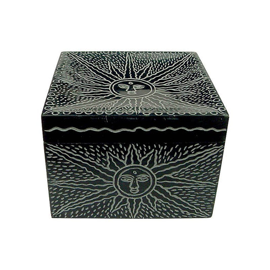 Black decorative trinket box with sun and face design on a white background