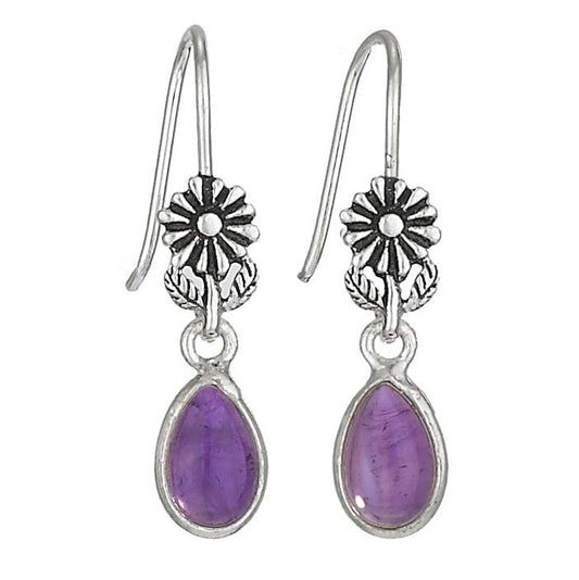 Silver flower earrings with purple teardrop stones on a white background