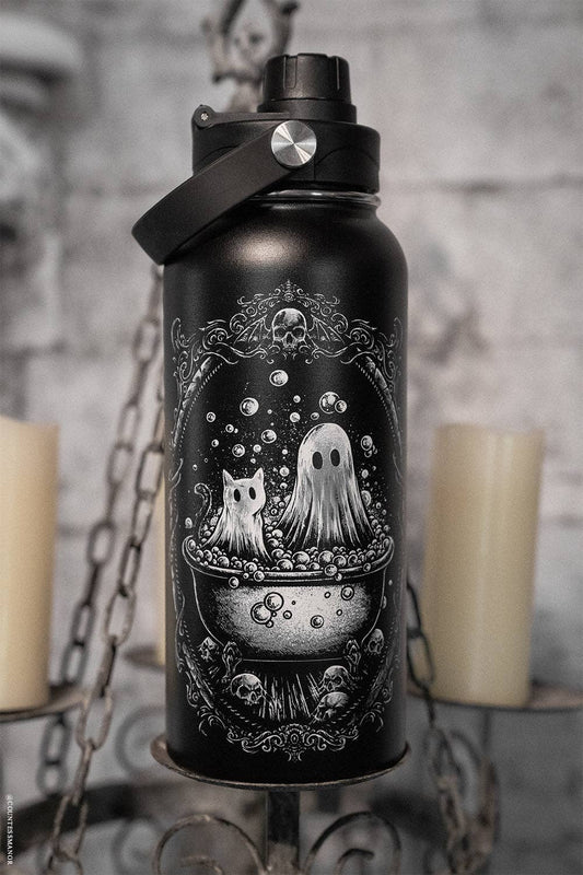 Black water bottle with ghost and cat design against a gray brick wall.