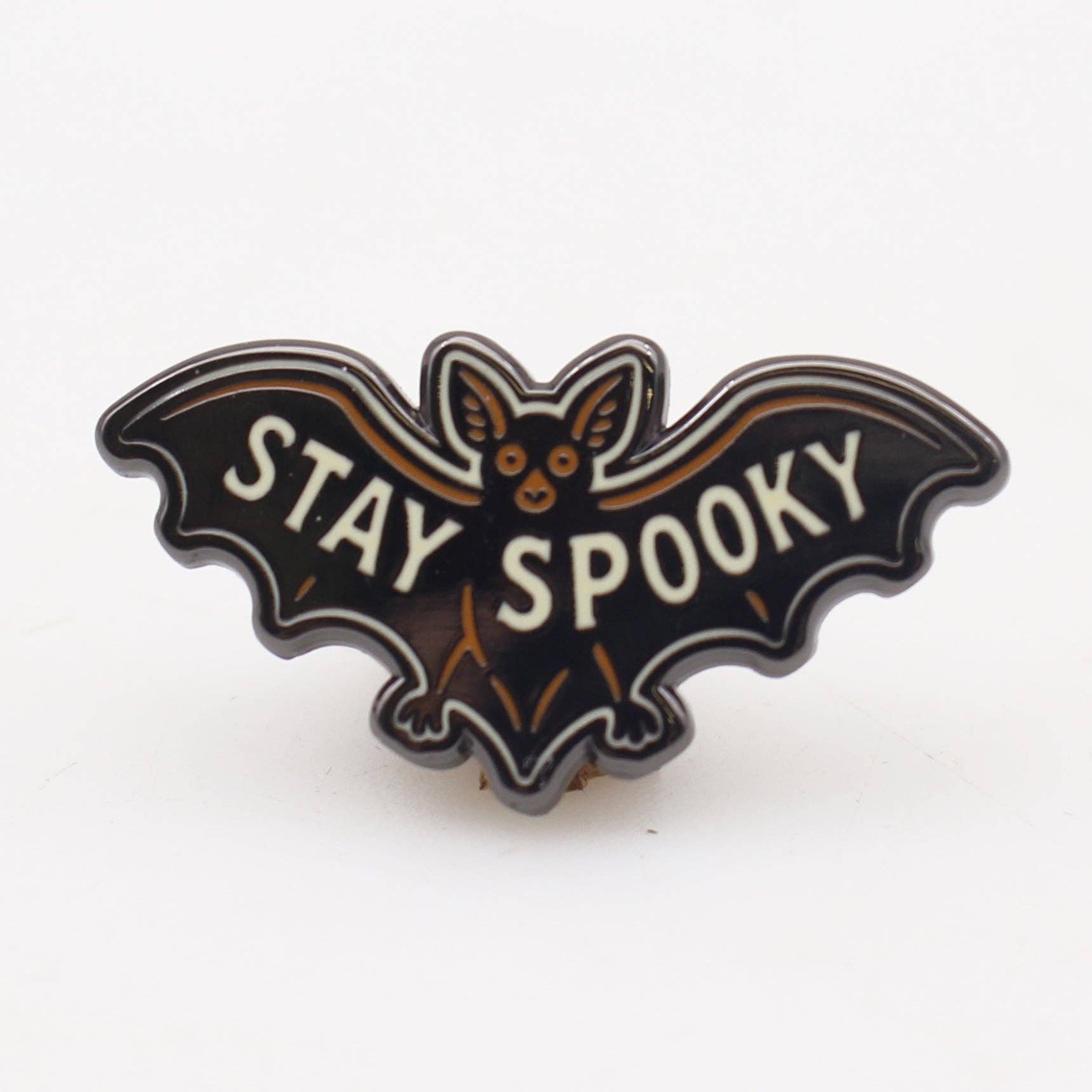 Bat-shaped pin with 'Stay Spooky' text on a white background