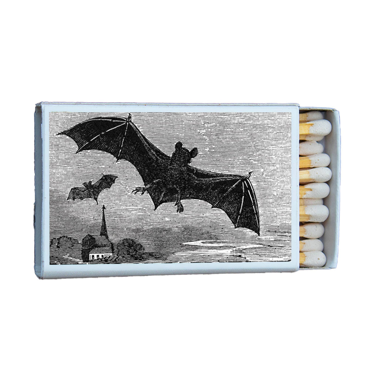 Matchbox with illustration of bats flying over a cityscape on a white background