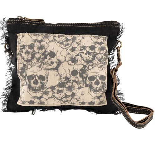 Shoulder bag with skulls pattern on a white background