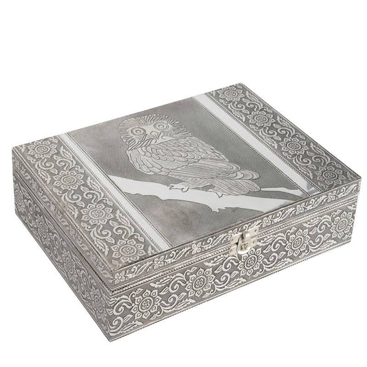 Decorative silver jewelry box with owl design on a white background