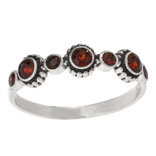Silver ring with seven brown gemstones on a white background
