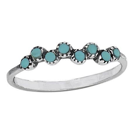 Silver ring with turquoise stones on a white background