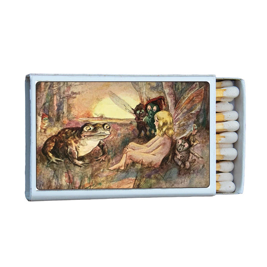 Matchbox with fairy and frog illustration on a white background