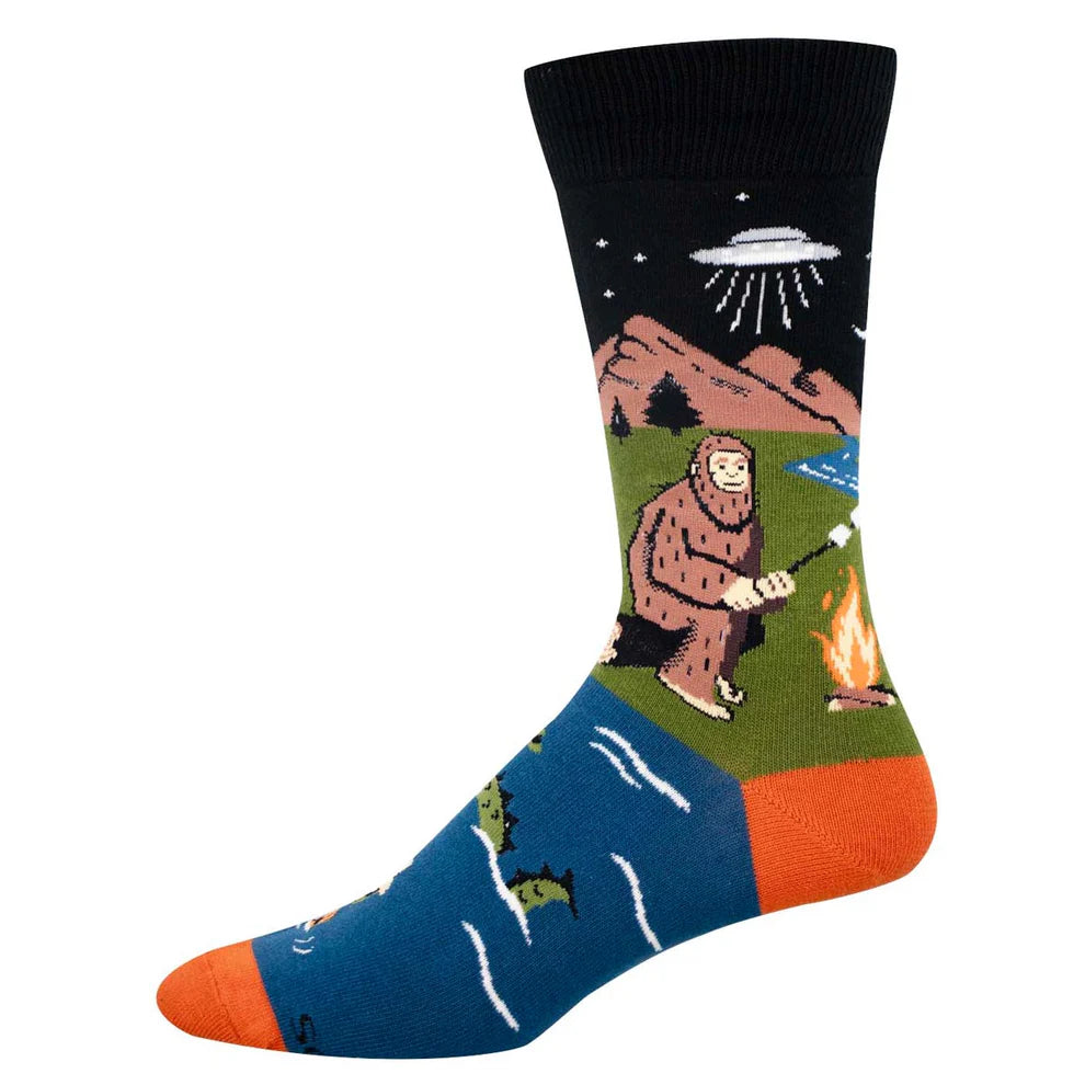 Colorful sock with a big foot roasting a marshmallow over a campfire design on a white background