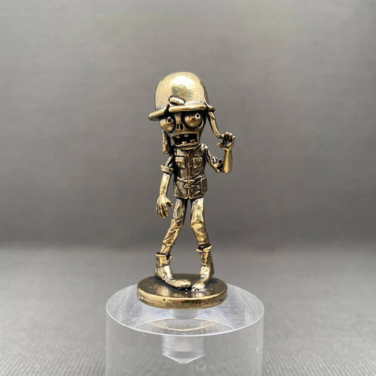 Bronze figurine of a zombie soldier on a clear stand against a gray background