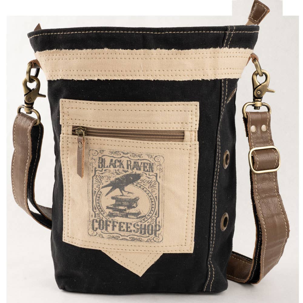 Black and beige crossbody bag with a visible brand logo on a white background