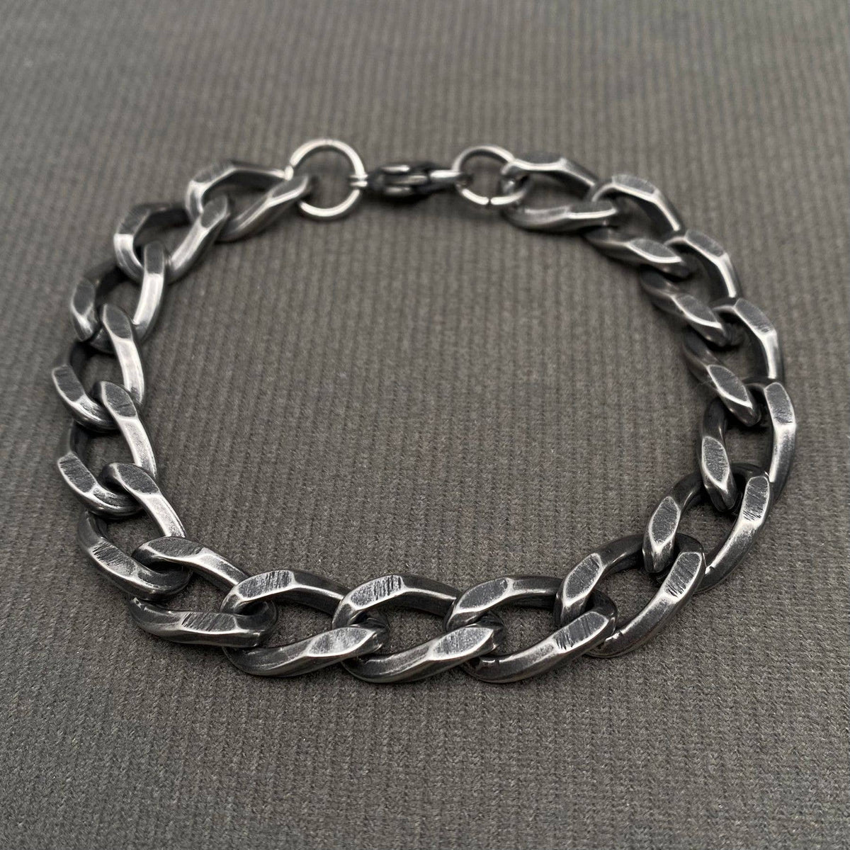 Silver chain bracelet on a gray background
