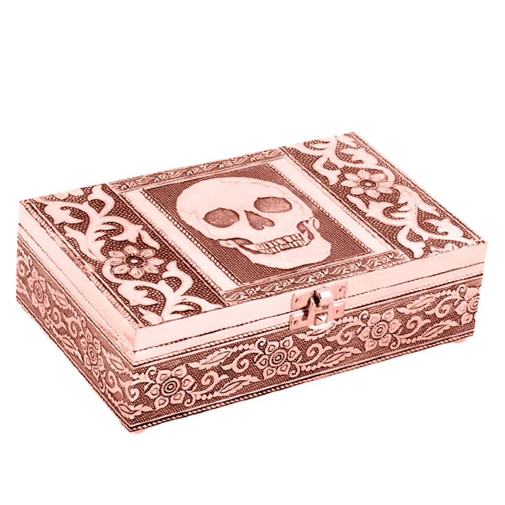 Decorative copper box with skull design and intricate patterns on a white background