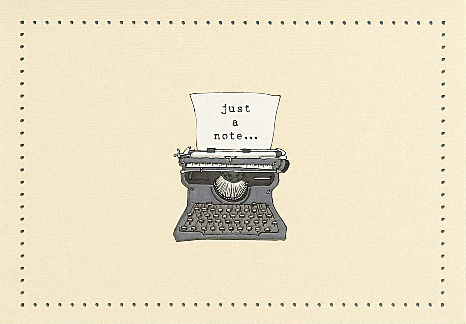 Vintage typewriter with a piece of paper reading 'just a note...' on a notecard with a beige background