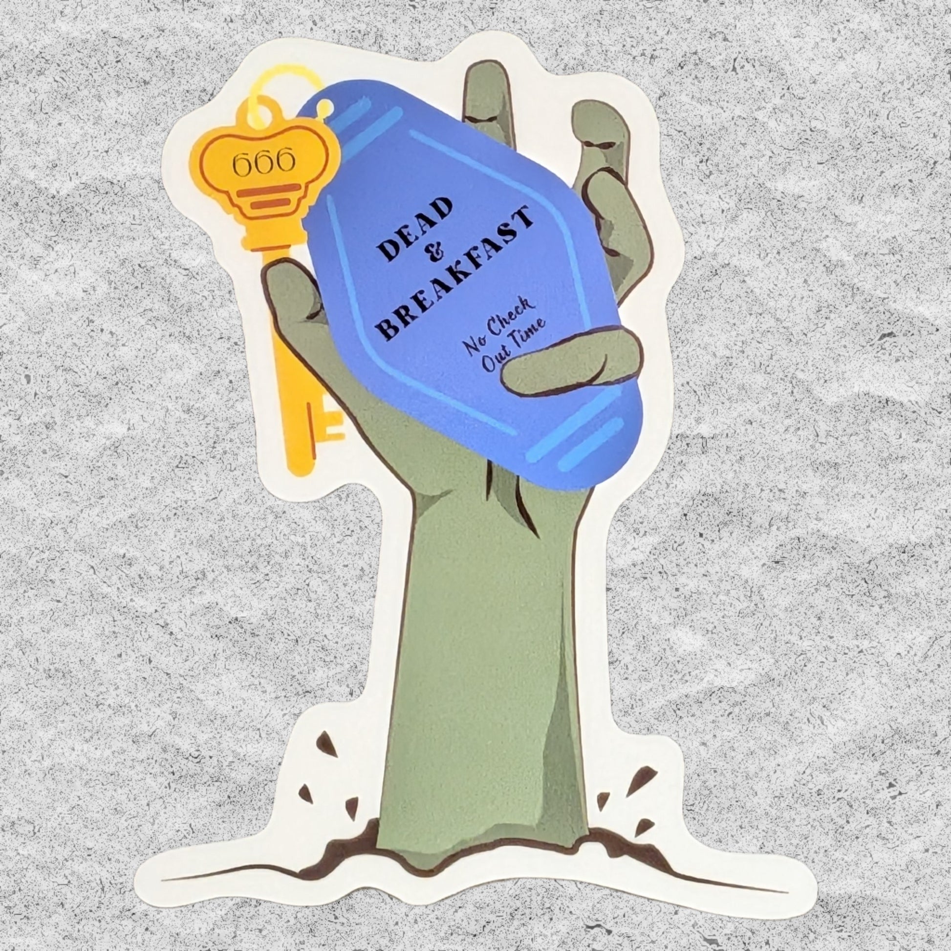 A die-cut sticker featuring a cartoon zombie hand holding a blue keychain that reads 'DEAD OR BREAKFAST No Check Out Time' and a gold key, shown on a textured gray background.