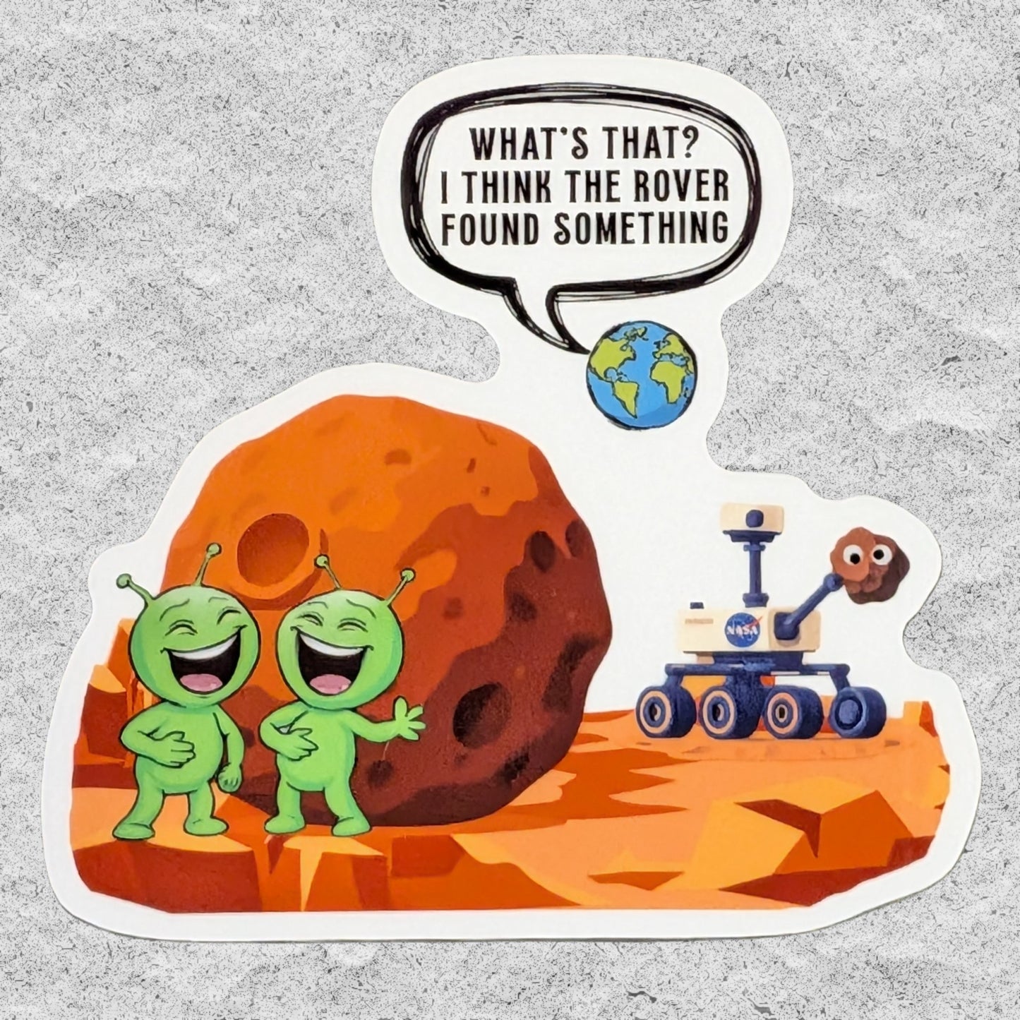 A die-cut sticker featuring two laughing green aliens and a Mars rover on an orange Mars landscape, with a speech bubble reading 'WHAT'S THAT? I THINK THE ROVER FOUND SOMETHING' and a small Earth illustration.
