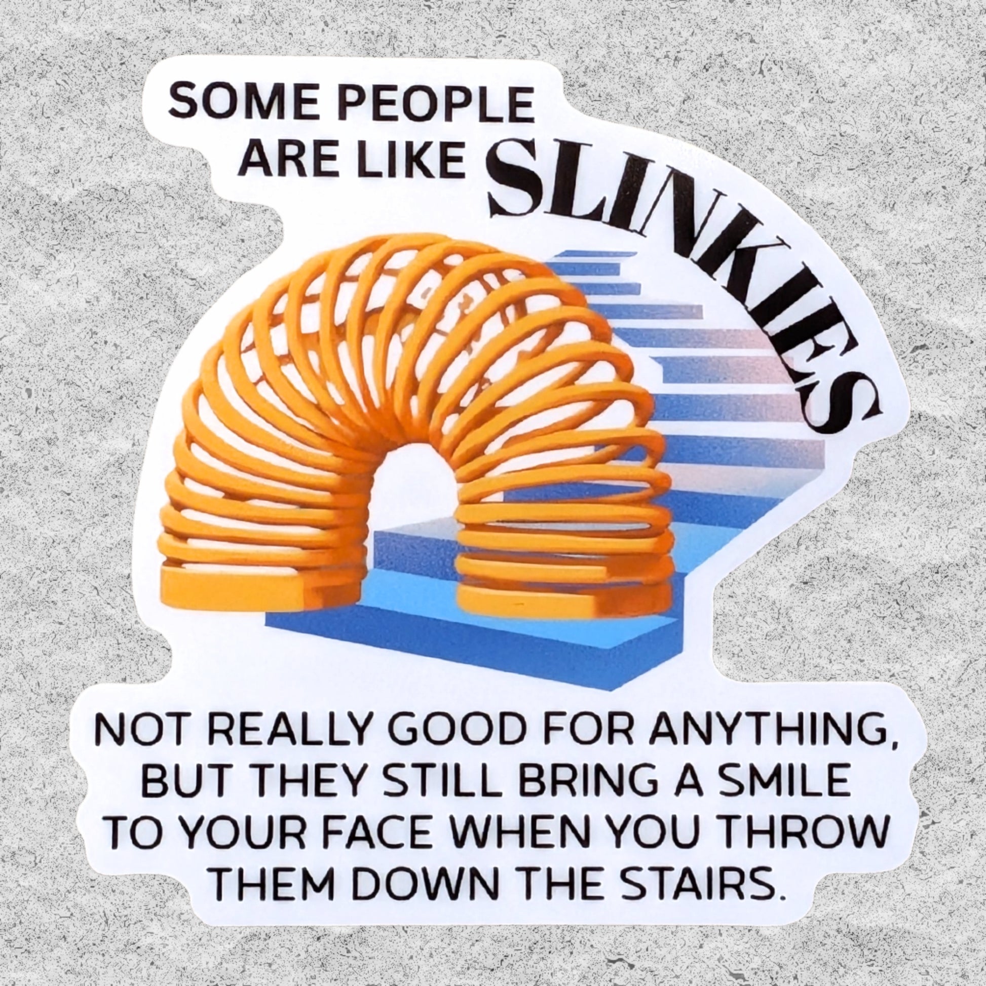 A die-cut sticker featuring a humorous quote about 'people are like slinkies', with an illustration of a coiled orange Slinky on blue stairs, shown on a textured gray background.