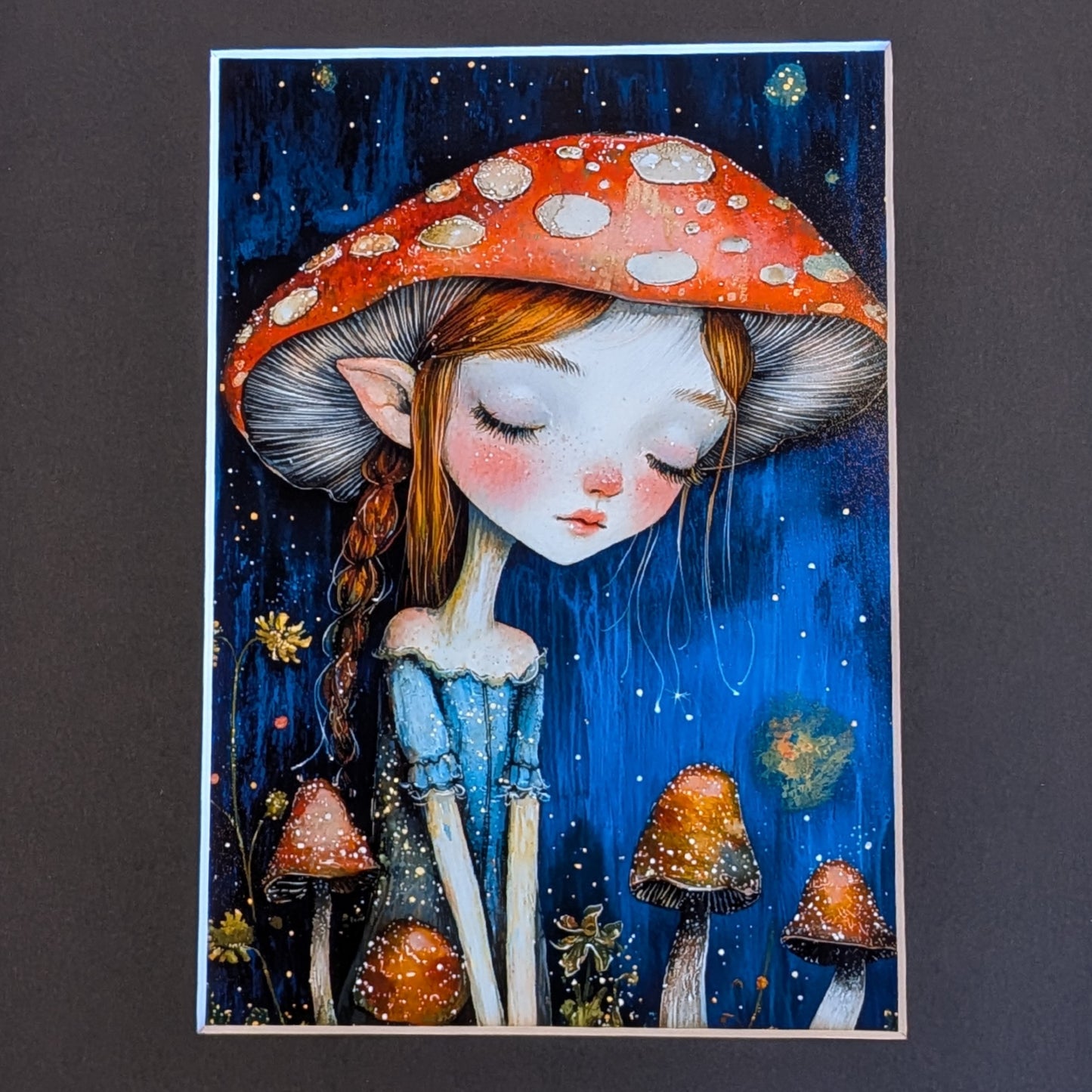 A vertical art print featuring a whimsical illustration of a girl with closed eyes, red hair in a braid, and large pointed ears, wearing a red mushroom cap with white spots against a dark blue starry background. Smaller mushrooms and flowers appear at the bottom.