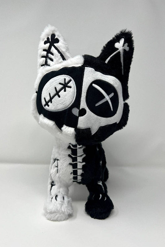 Black and white skeleton cat plush toy on a light gray background