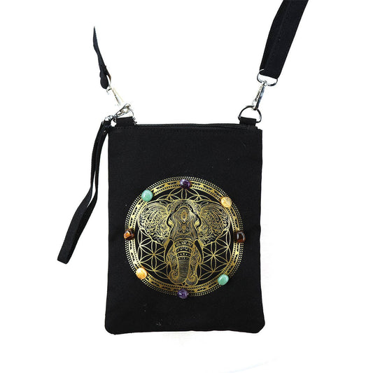 Black bag with gold elephant design and colorful stones on a white background