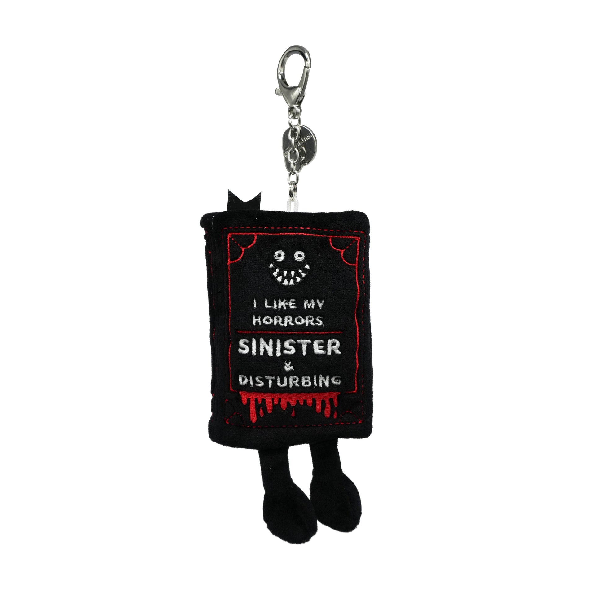 Keychain with text 'I like my horrors sinister and disturbing' on a white background